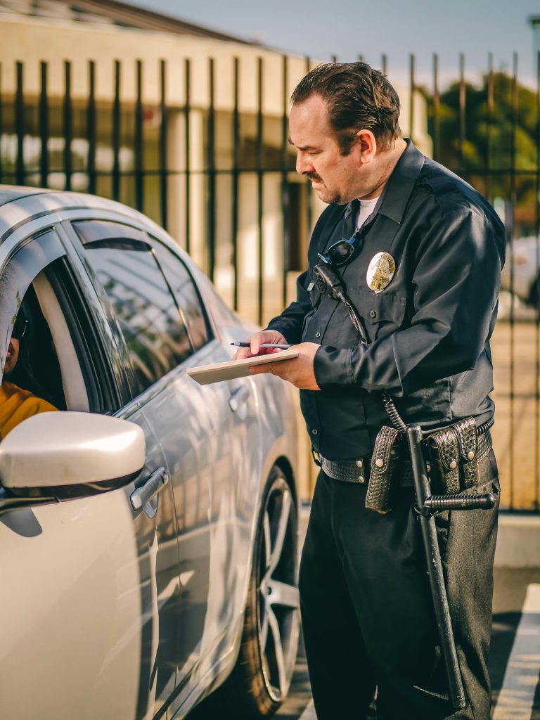 A police officer writing a traffic ticket