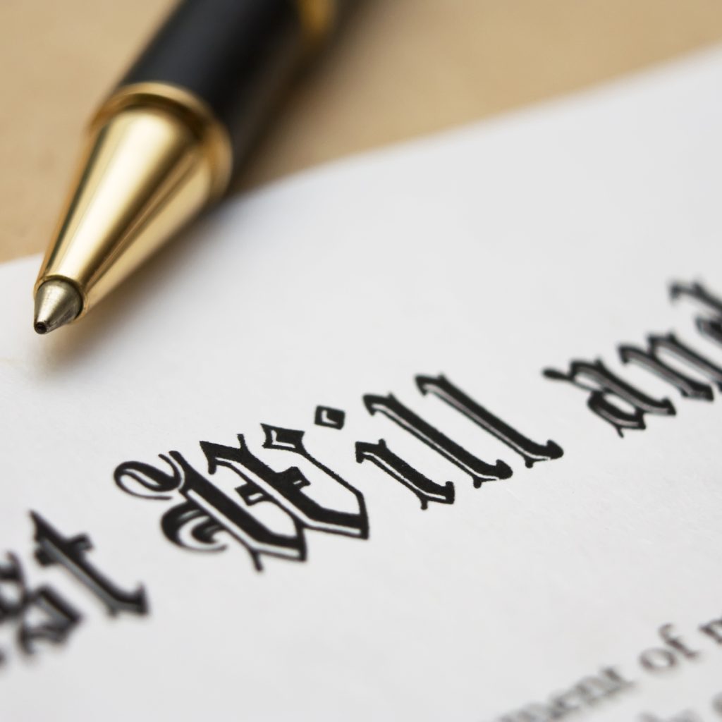 Close-up of a Last Will and Testament document with a pen on top.